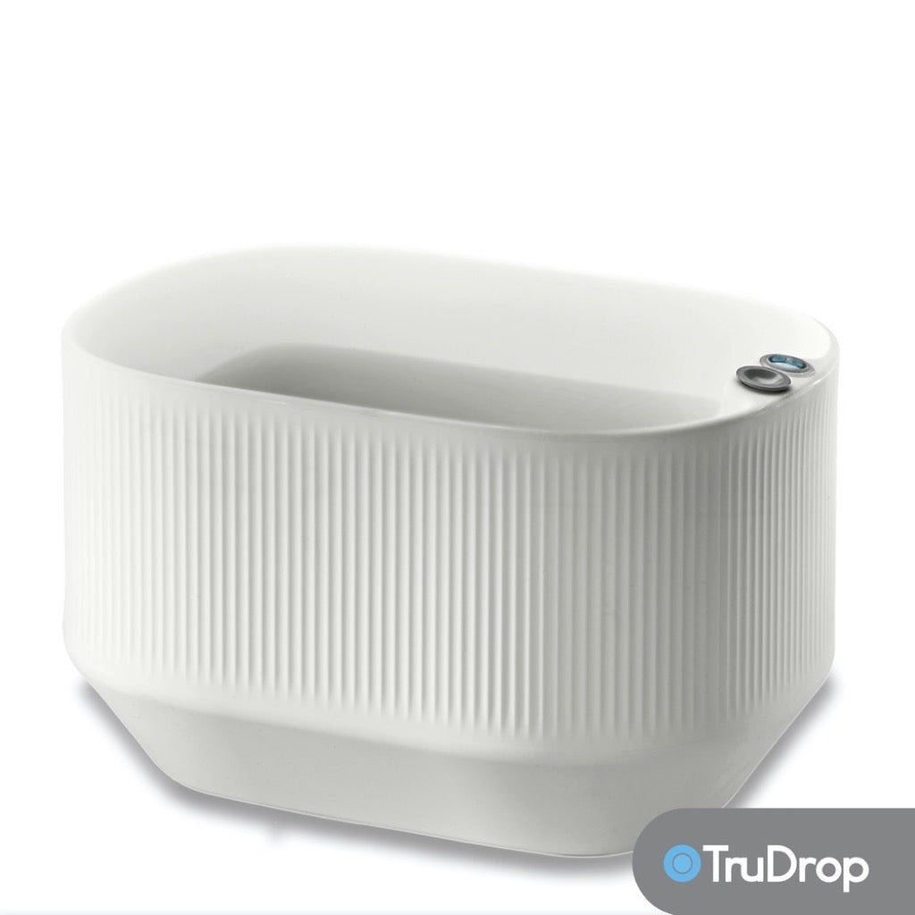 White toilet bowl with textured design on a white background, featuring the TruDrop brand.